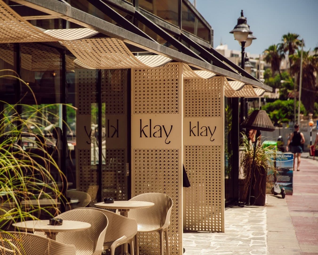Klay's terrace on the Balluta promenade, with latticed panels bearing the Klay name
