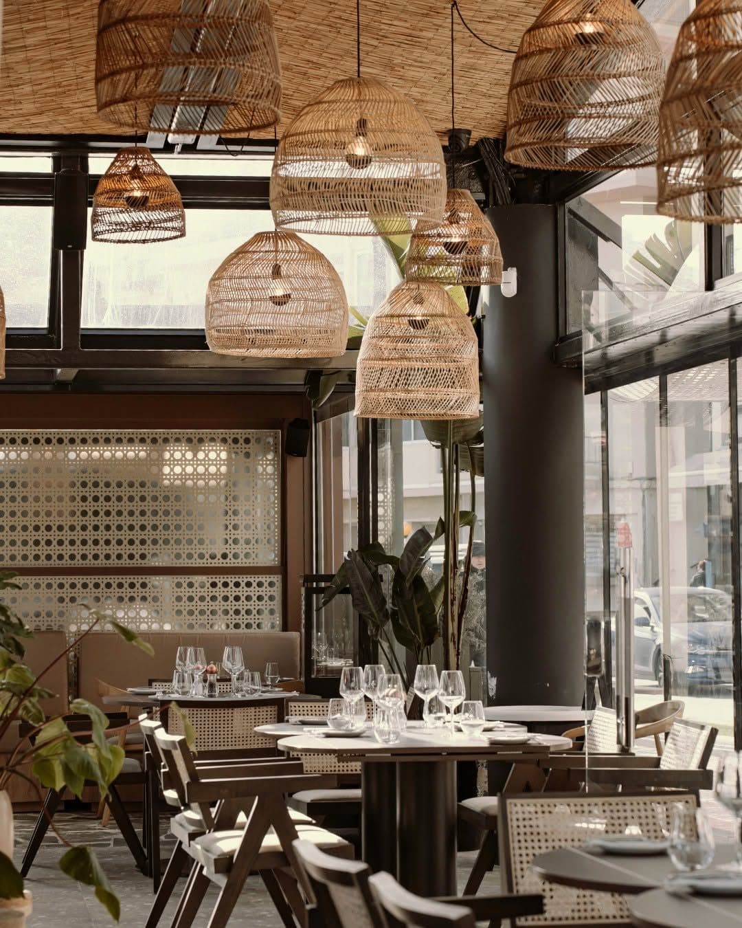 Clusters of woven rattan pendant lamps over the dining room