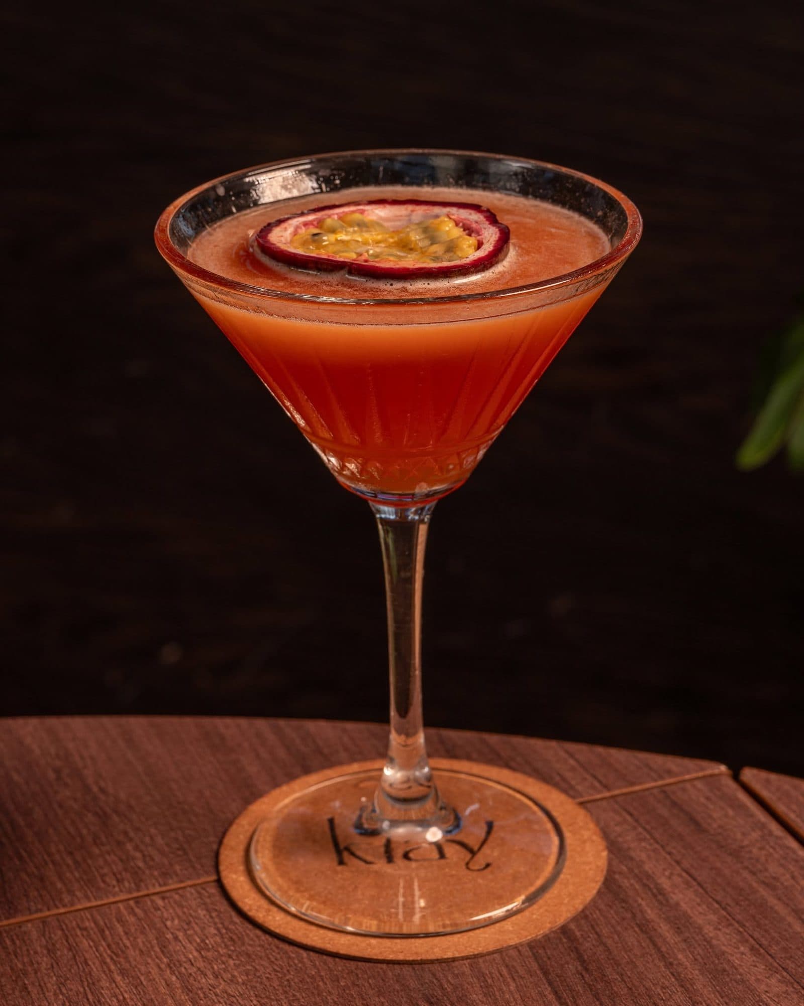 A passion fruit martini on a cork Klay coaster